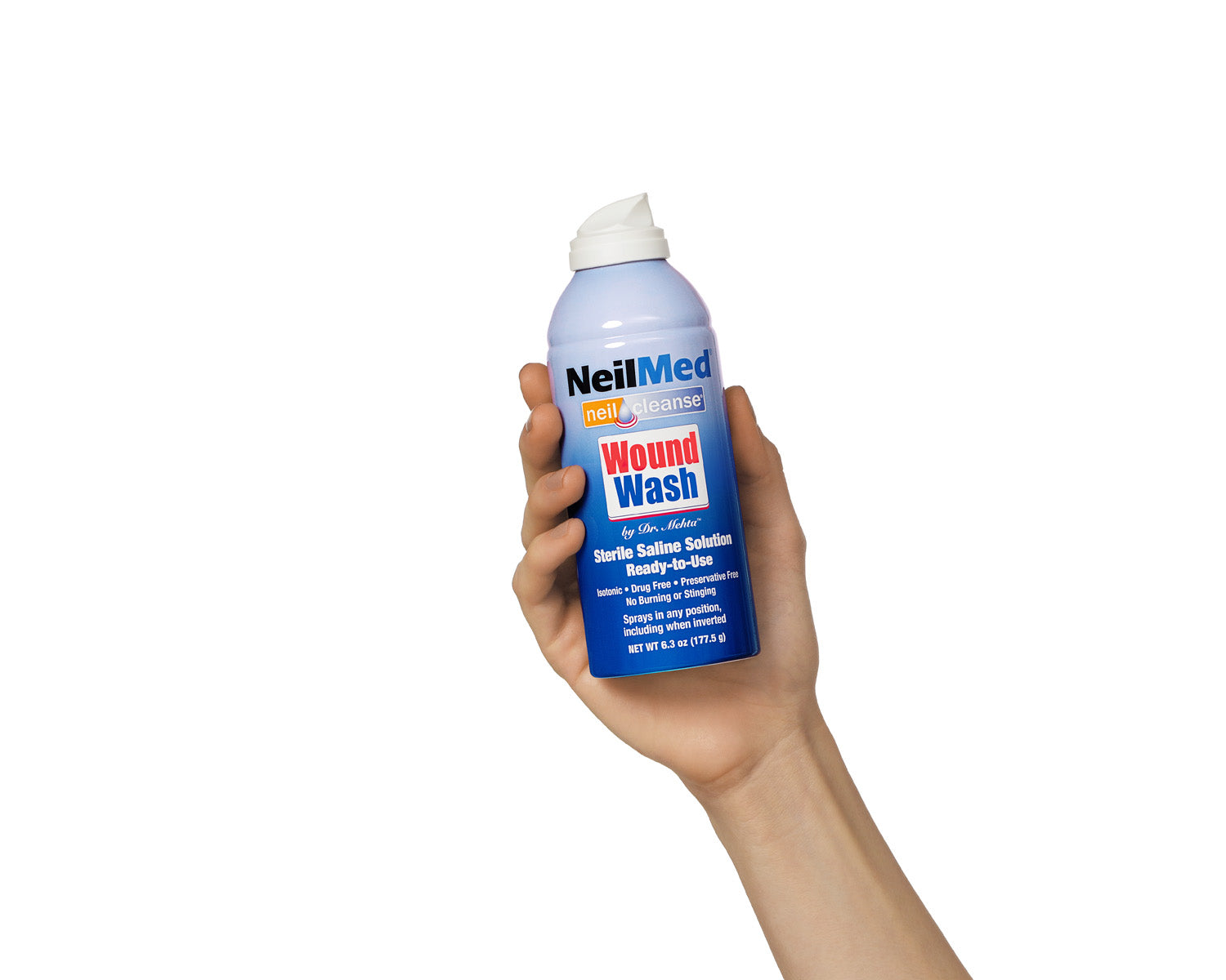 Hand holding a can of NeilMed Wound Wash on a white background